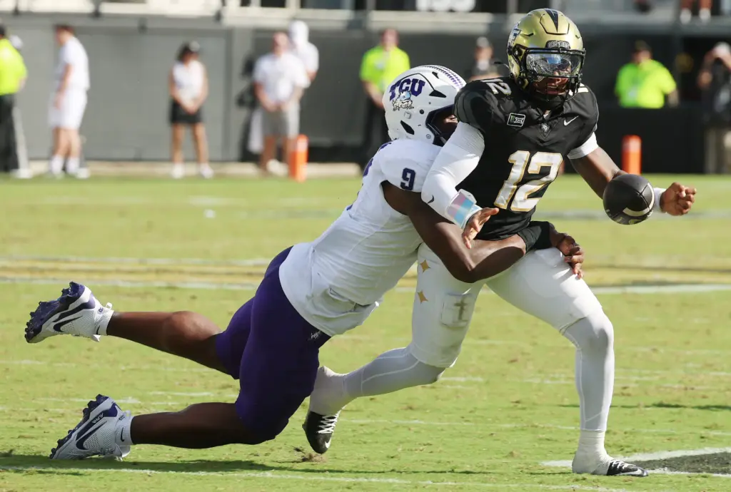 UCF quarterback Keyone Jenkins (12) temporarily loses the ball during...