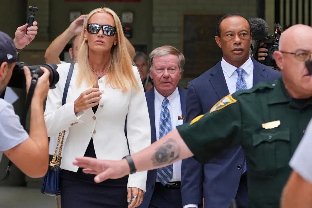 Golfer Tiger Woods leaves with Vanessa Trump after Woods' plea conference hearing.