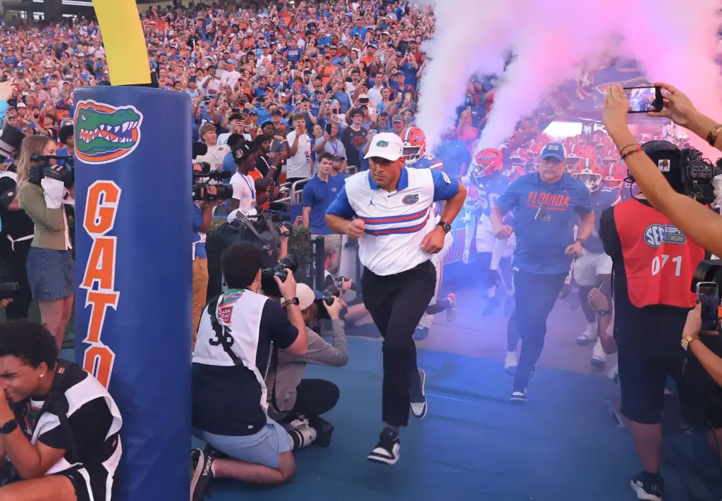 Florida head coach Jon Sumrall leads his team onto the...