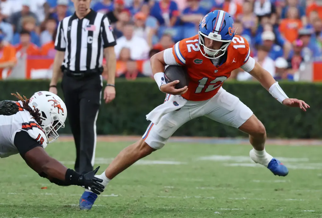 Florida qurterback Aaron Philo scrambles during the Campbell University at...
