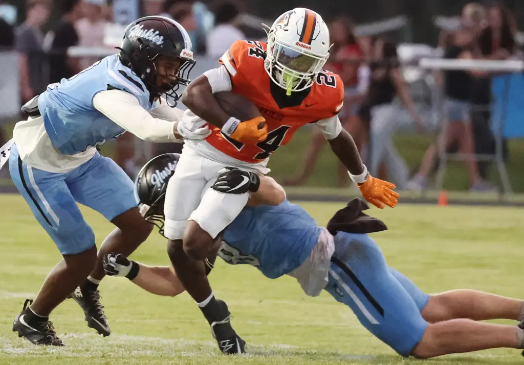 Oviedo running back Johnnie Rollins (24) runs through defenders during...