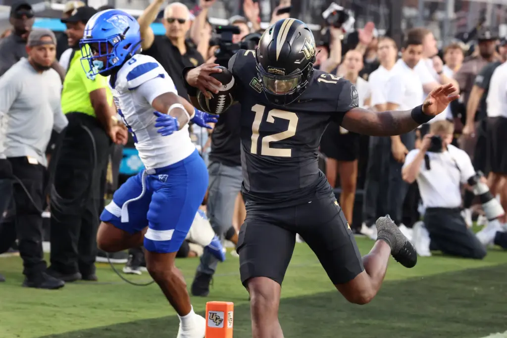UCF quarterback Keyone Jenkins (12) runs into the endzone for...