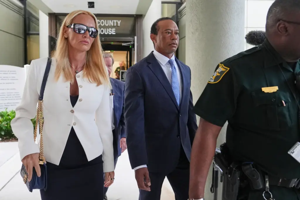 Golfer Tiger Woods leaves with Vanessa Trump after Woods' plea conference hearing.