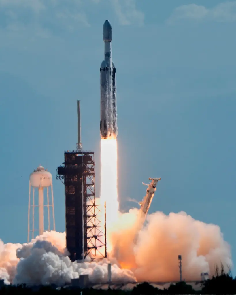 A SpaceX Falcon Heavy rocket lifts off from pad 39A...
