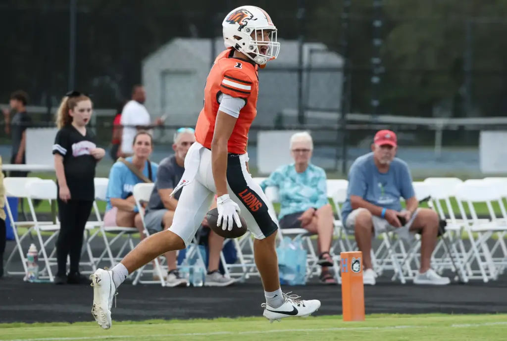 Oviedo receiver Jordan Donahoo (1) celebrates as he scores a...