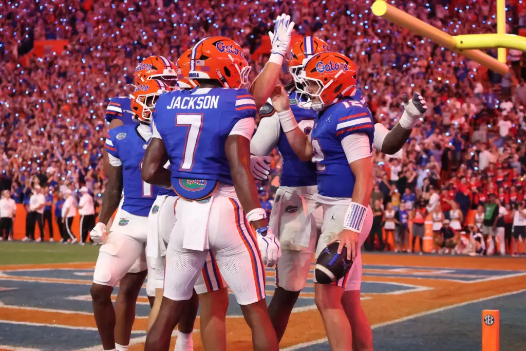 Florida quarterback Aaron Philo (12) celebrates with teammates after running...