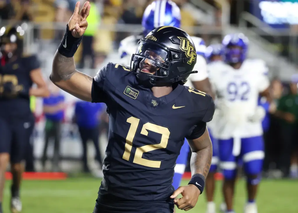 UCF quarterback Keyone Jenkins (12) celebrates after he scored a...