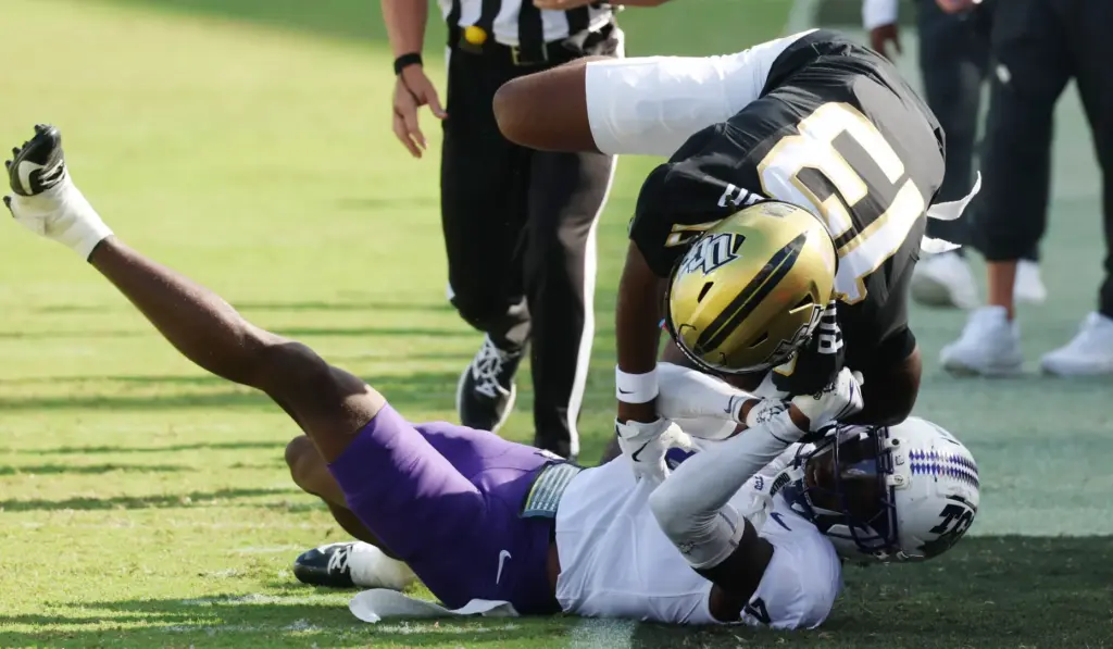 UCF wide receiver Caleb Rollerson (13) falls out of bounds...