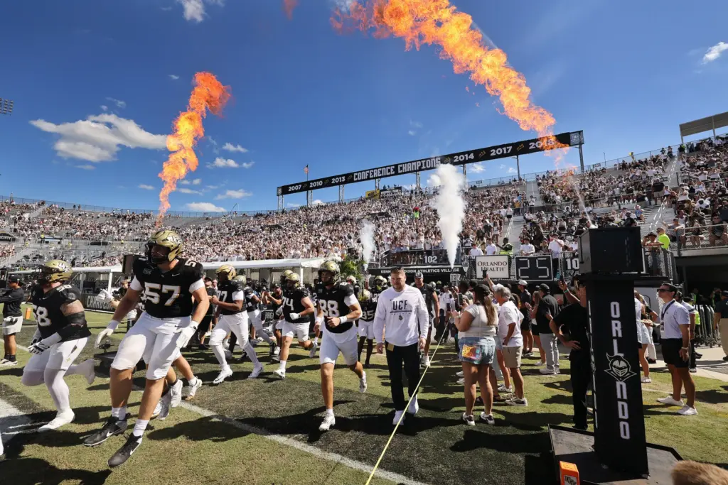 UCF players run onto the field for the TCU at...