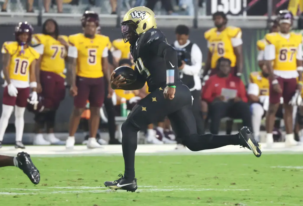 UCF quarterback Alonza Barnett III (14) runs for a touchdown...