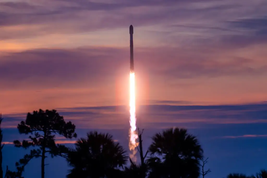 A SpaceX Falcon 9 with a first-stage booster flying for...