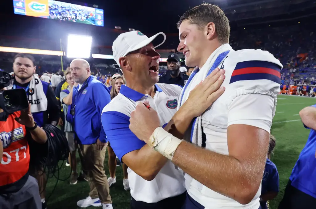 Florida head coach Jon Sumrall shares a moment with FAU...