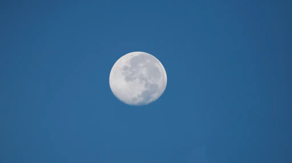 A full moon is visible from the Launch Complex 39...