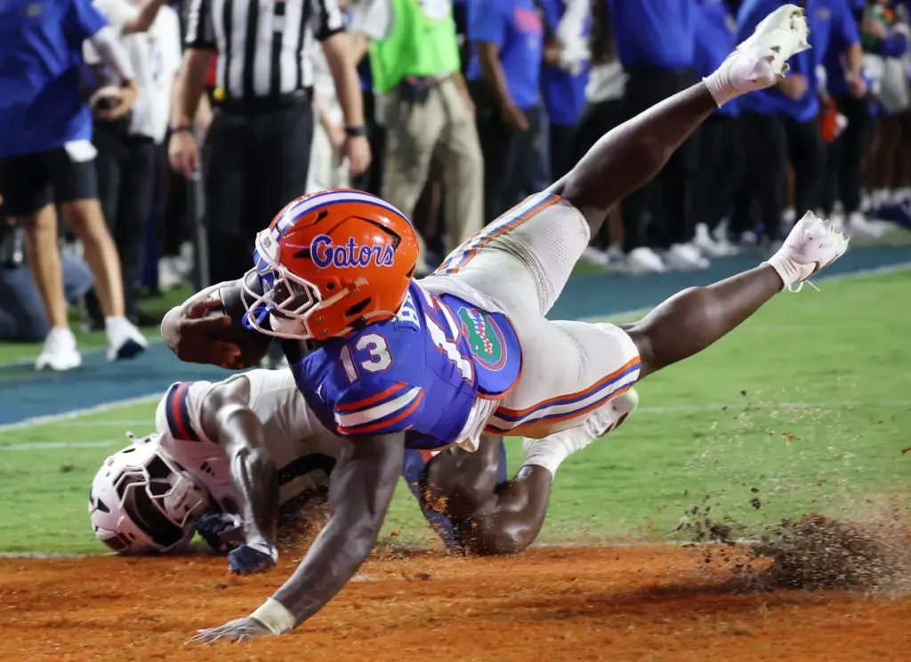 Florida running back Jadan Baugh (13) leaps into the endzone...