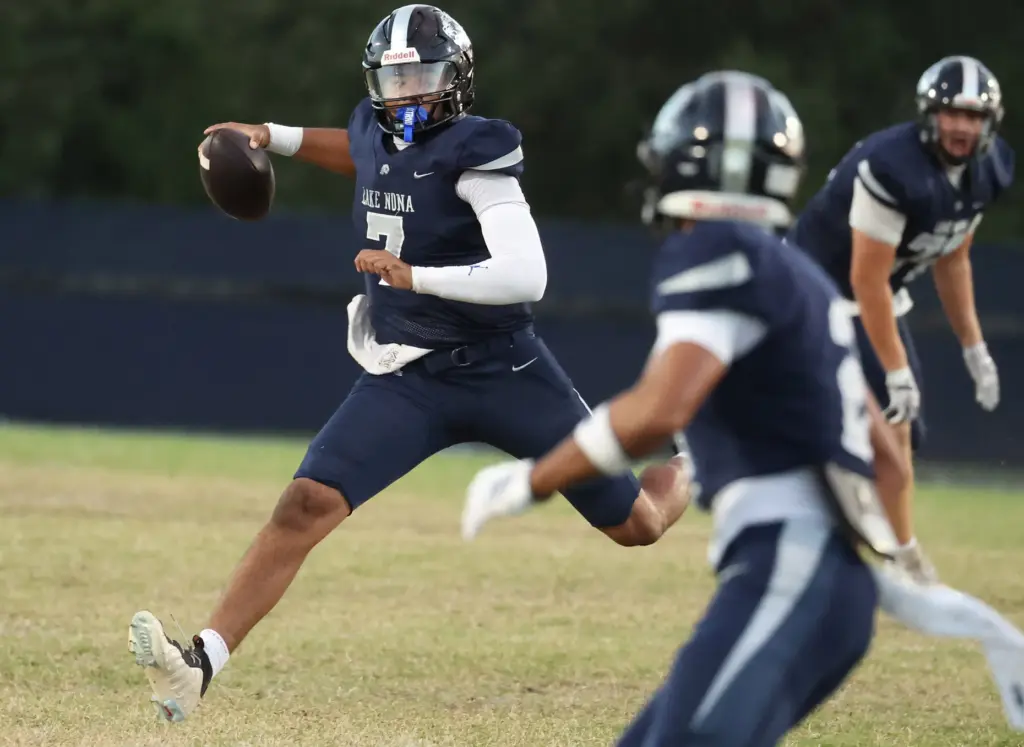Lake Nona quarterback Elijah Nickerson (7) scrambles during the St....