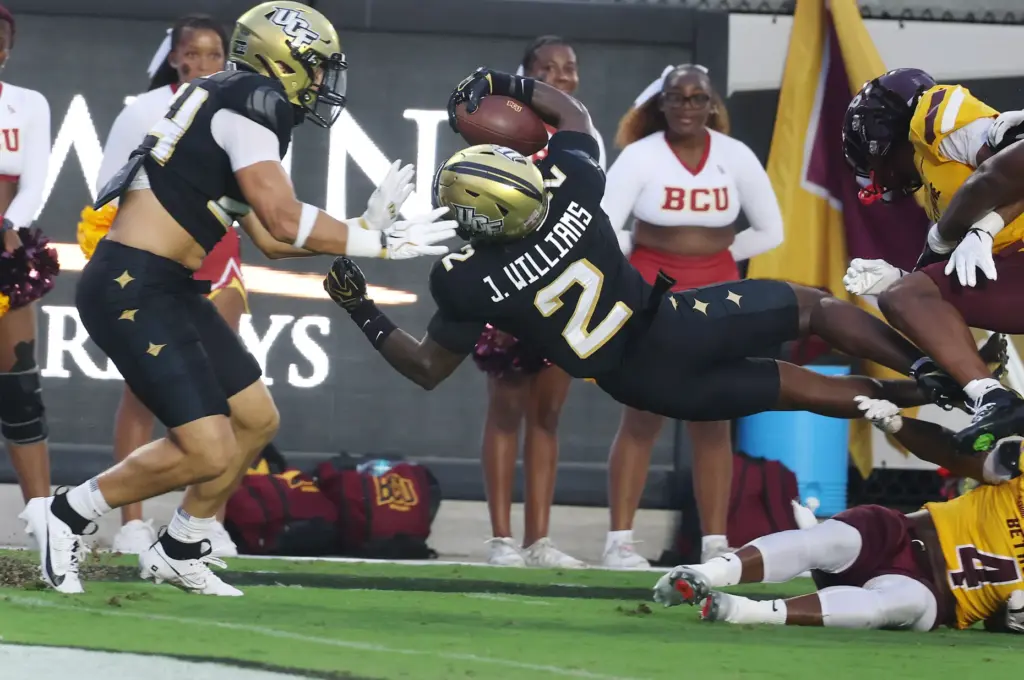 UCF defensive back Jayden Williams leaps into the endzone for...