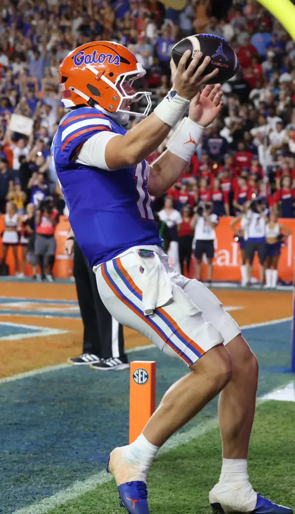 Florida quarterback Aaron Philo (12) celebrates after running for a...