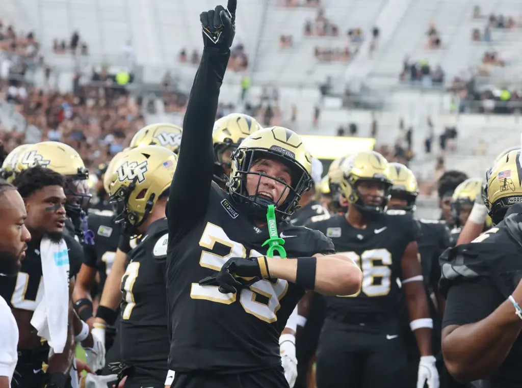 UCF wide receiver Andrea Parisi (39) and others cheer before...