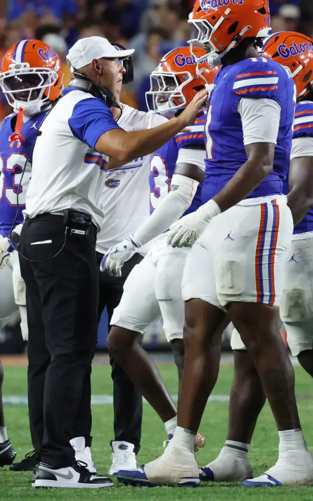 Florida head coach Jon Sumrall gets in a word with...