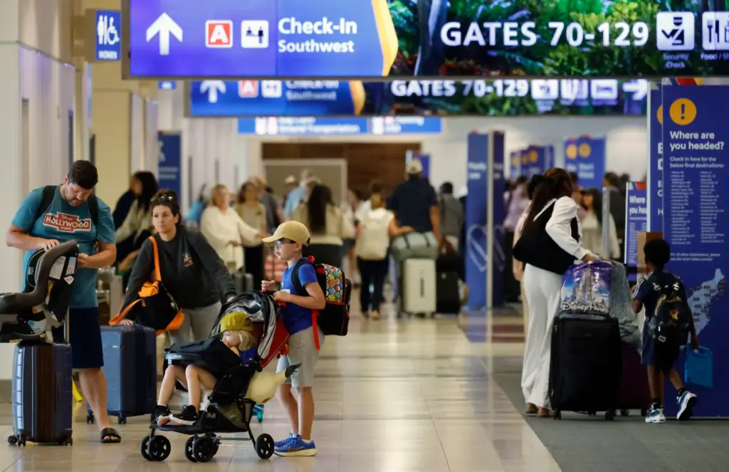 Travelers at the ticketing area of the Orlando International Airport,...
