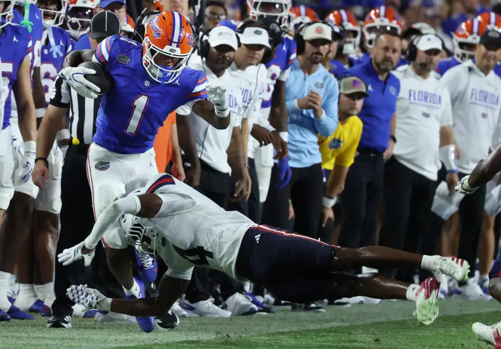 Florida wide receiver Vernell Brown III (1) is knocked out...