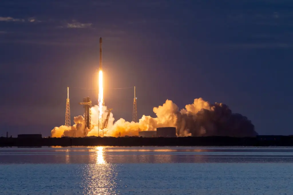 A SpaceX Falcon 9 with a first-stage booster flying for...