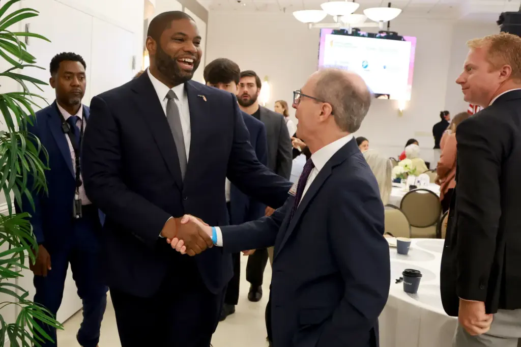 Republican gubernatorial nominee Byron Donalds greets Shane Strum, president and CEO of both Broward Health and Memorial Healthcare System, during the Sunshine Economy Summit in Fort Lauderdale on Wednesday, Sept. 23, 2026. (Mike Stocker/South Florida Sun Sentinel)