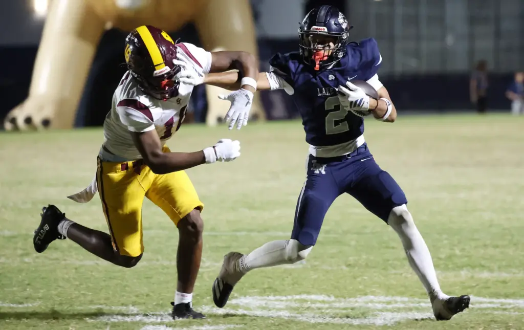Lake Nona player Sebastian Lora (2) shoves aside St. Cloud...