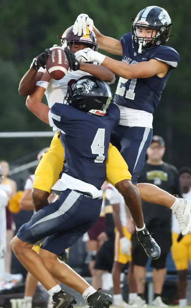 Lake Nona defenders Riley Kennedy (21) and Taebor Williams (4)...