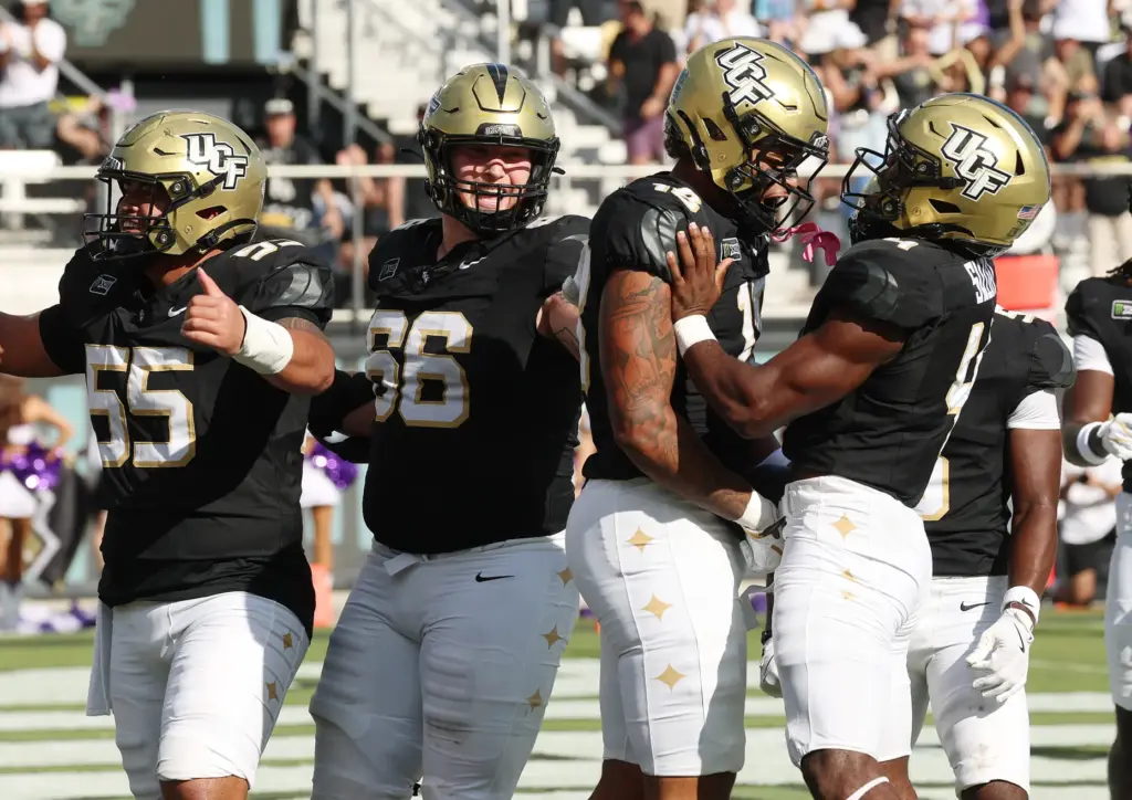 UCF tight end Caden Piening (18) celebrates with teammates after...