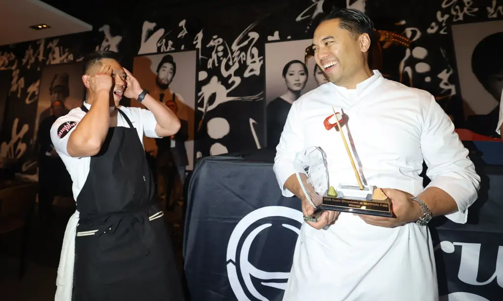 Chef Chau Trinh of Sushi Pop (left) reacts as he...