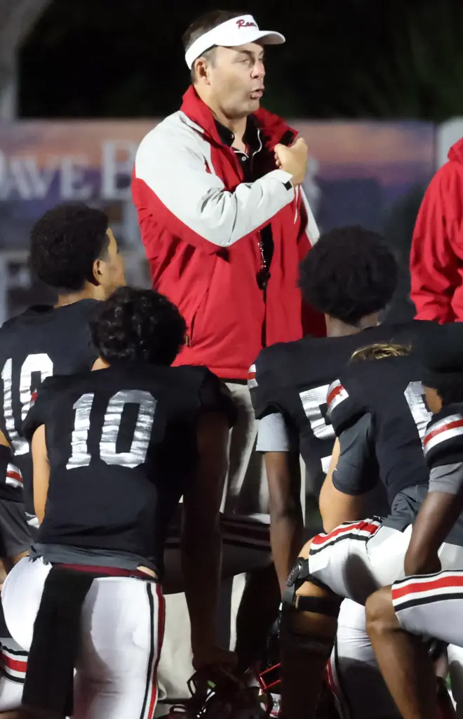 Lake Mary coach Scott Perry coaches players during the Osceola...