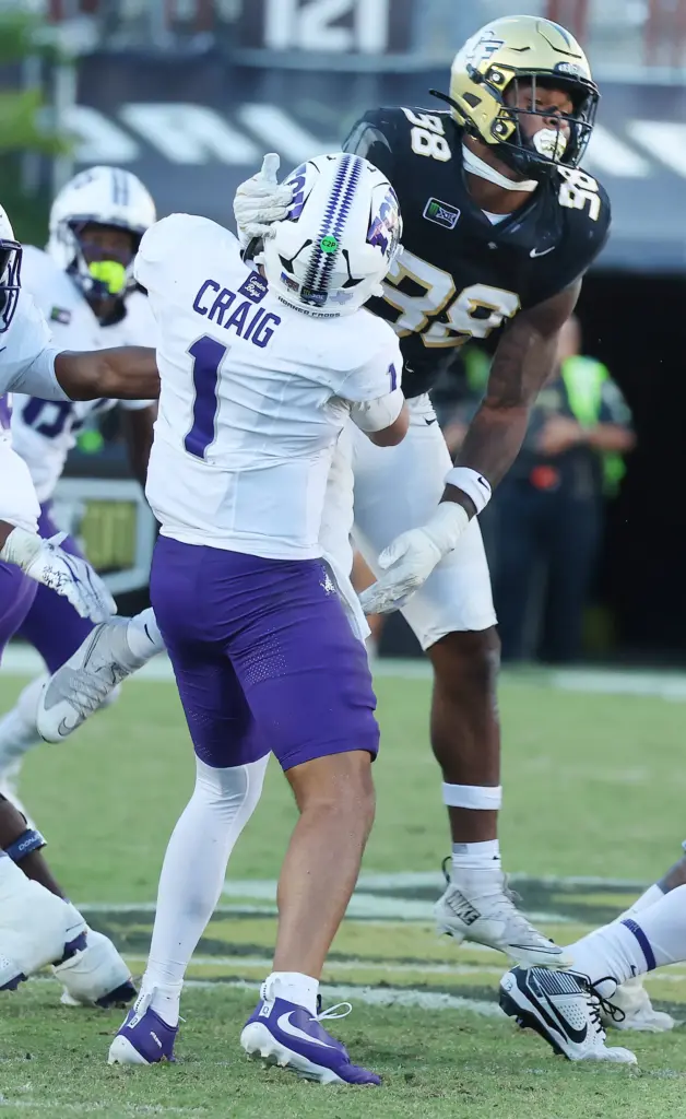 UCF linebacker Jayden Jennings (38) hits TCU quarterback Jaden Craig...