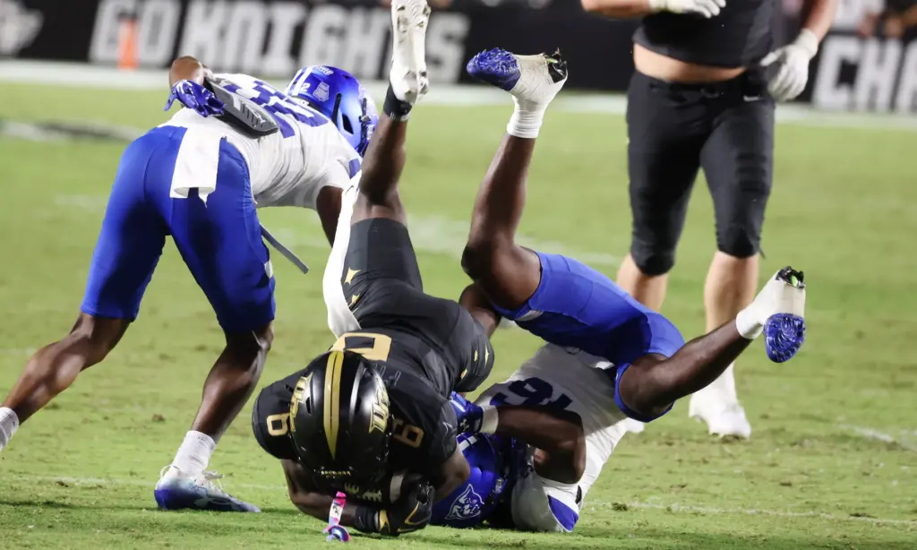UCF receiver Ric'Darious Farmer (6) leaps for extra yardage during...