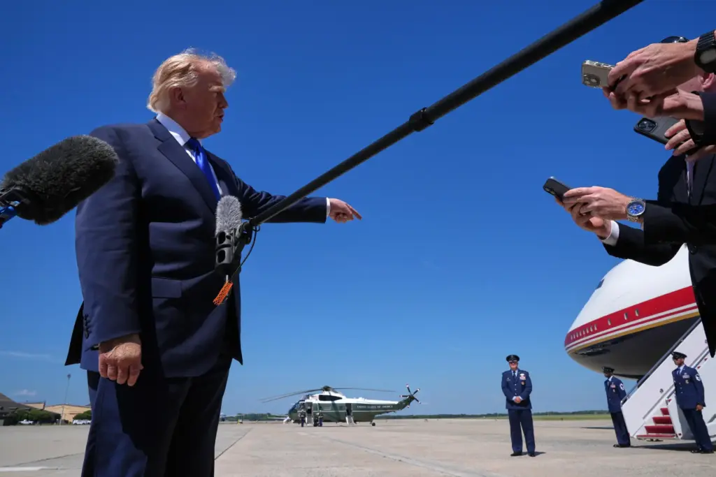 President Donald Trump talks with reporters after an emergency inflatable...