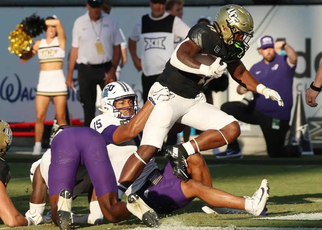 UCF running back Landen Chambers (11) leaps into the endzone...