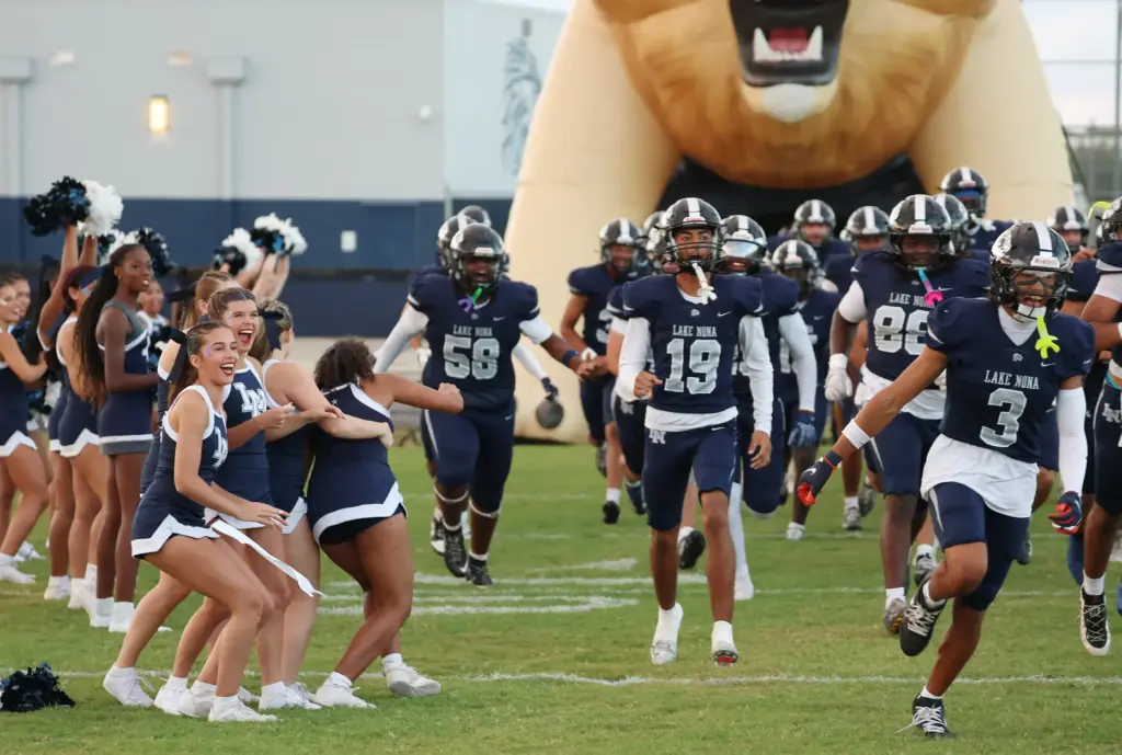 Lake Nona players run onto the field for the St....