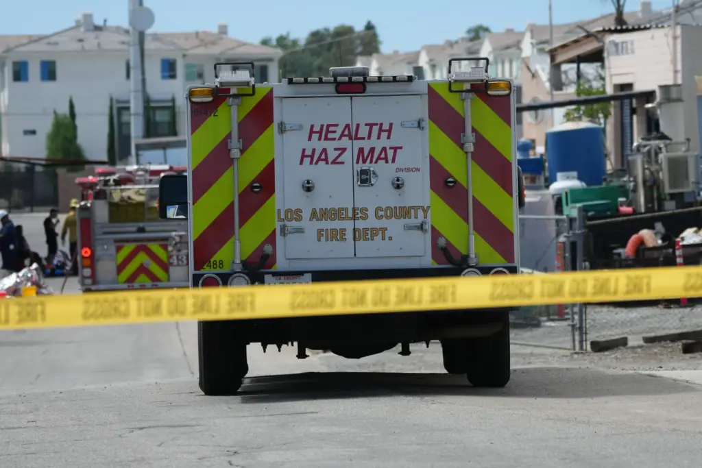 Emergency vehicles line a cordoned off street near a chemical...