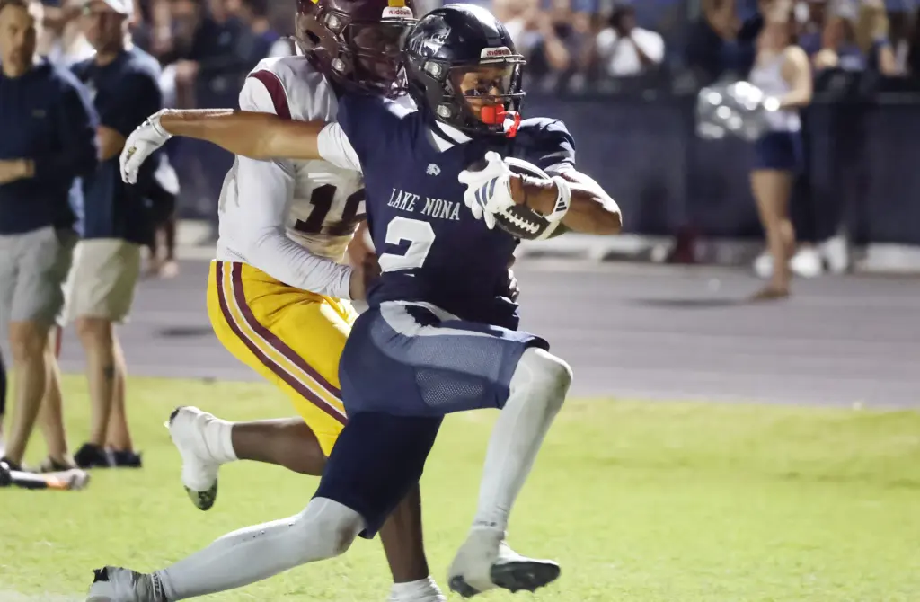 Lake Nona player Sebastian Lora (2) runs into the endzone...