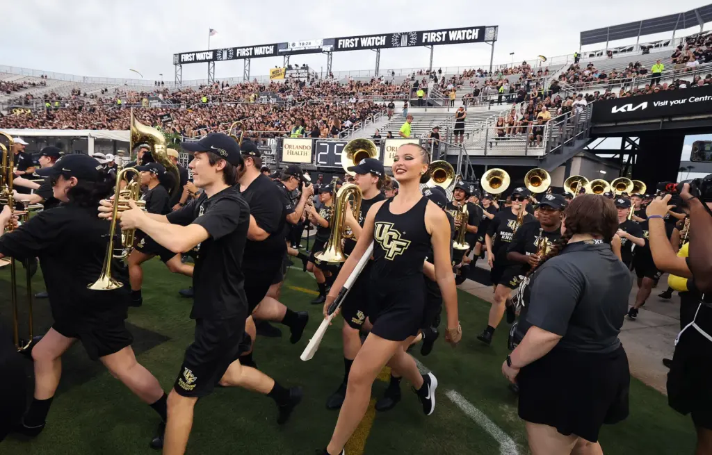 The UCF band runs onto the field before the Bethune-Cookman...
