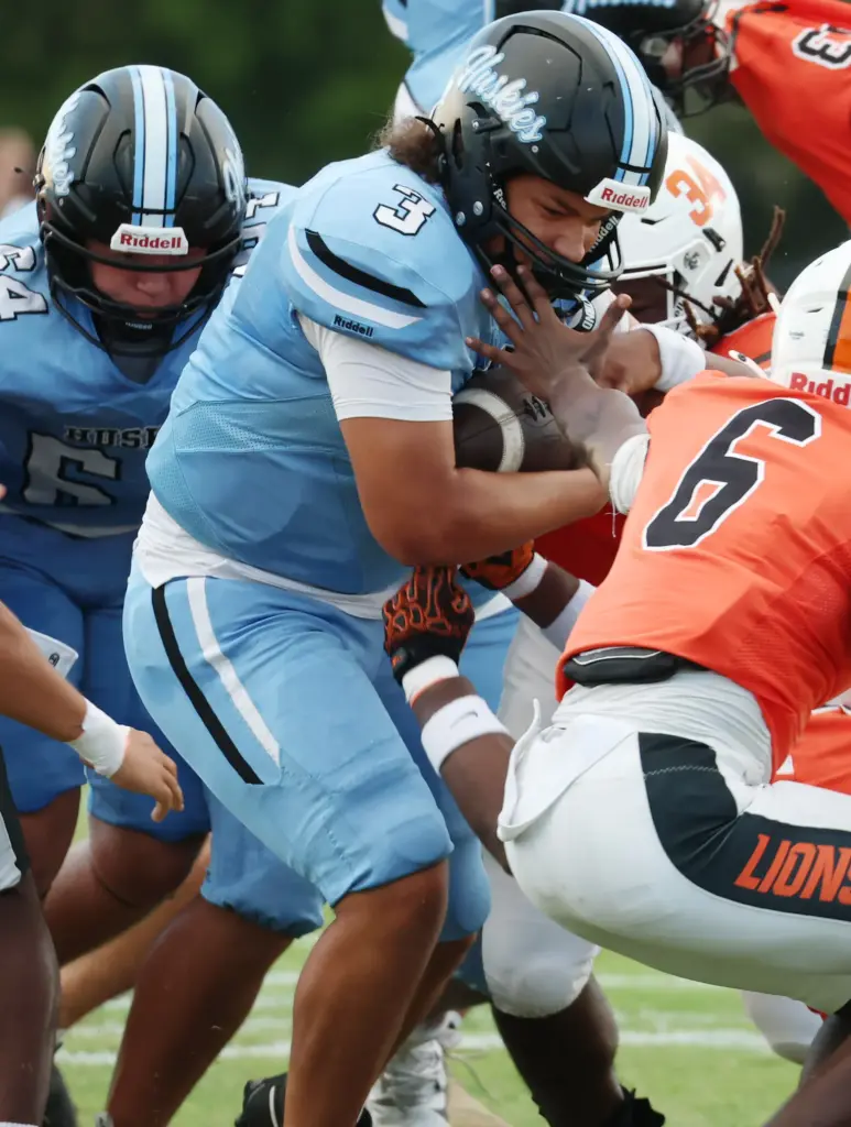 Hagerty quarterback Royce Jenkins (3) fights through the line during...