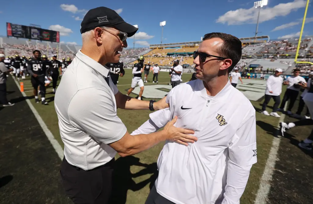 UCF athletic director Terry Mohajir, left, greets UCF quarterbacks coach...