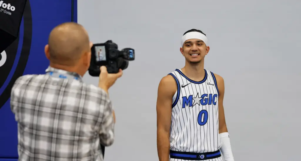 Phelan M. Ebenhack checks a photograph of Orlando Magic Guard...