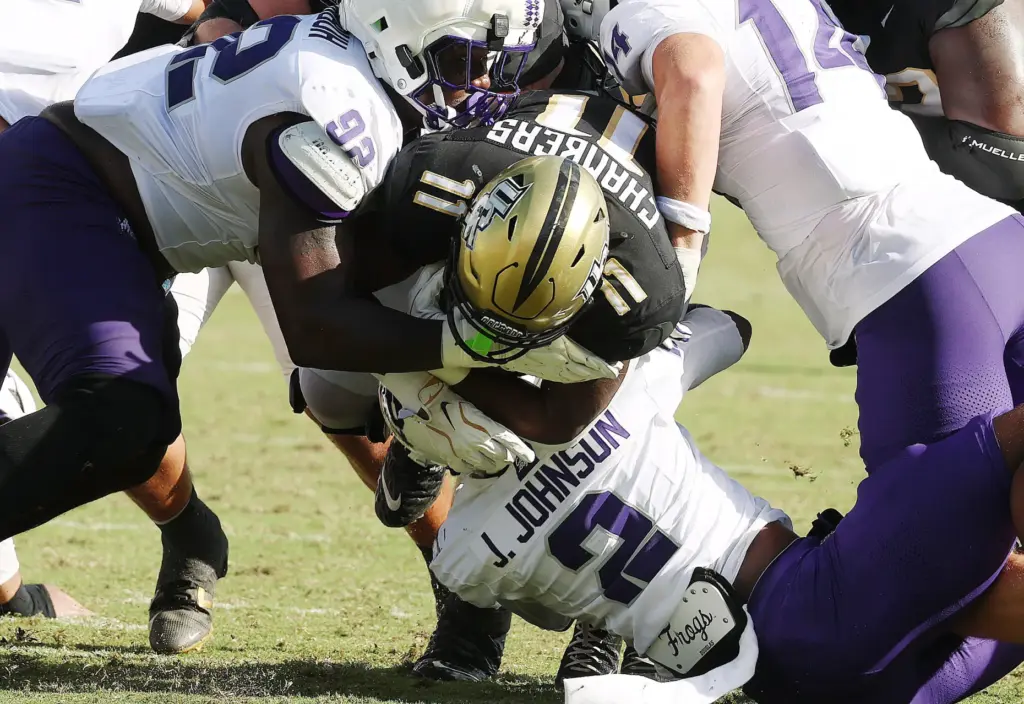 UCF running back Landen Chambers (11) slams through the line...