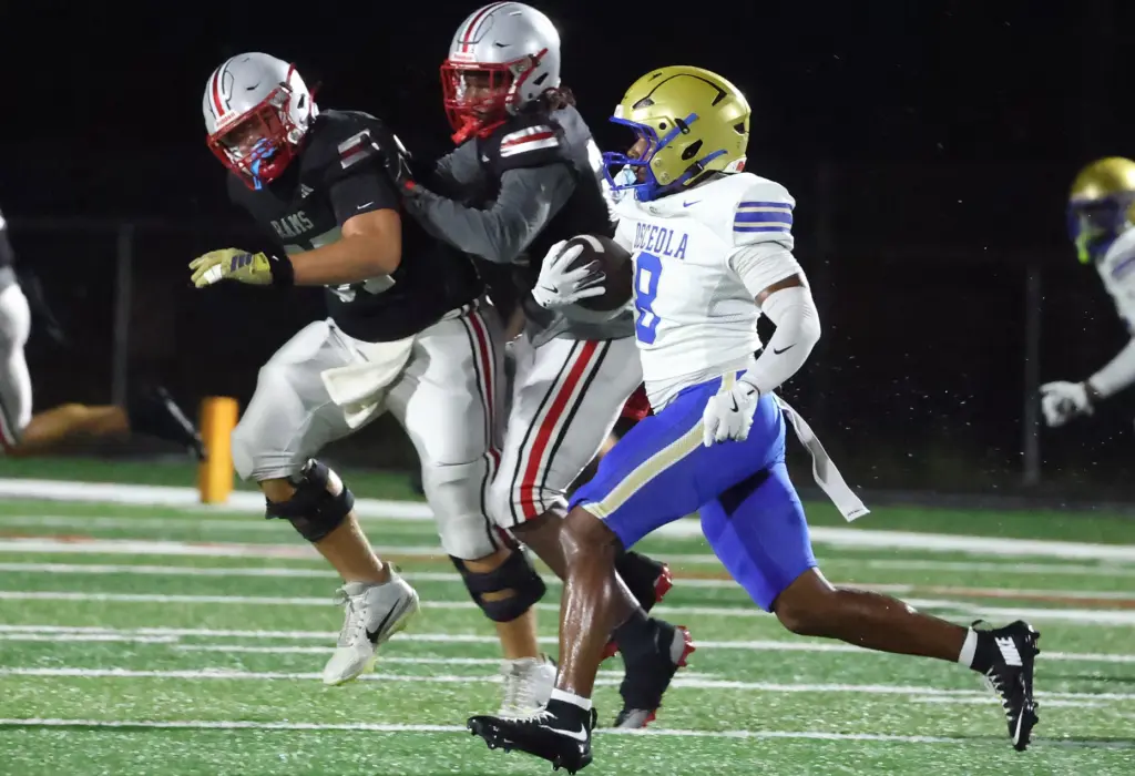 Osceola player Dorian Wright Jr. (8) runs after he intercepted...