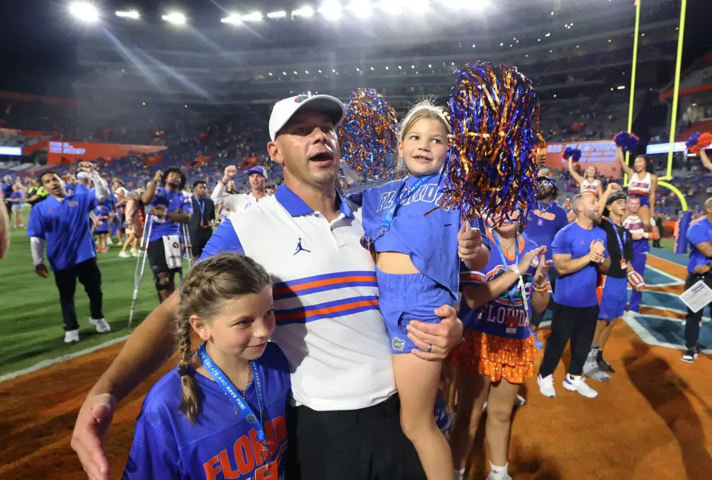 Florida head coach Jon Sumrall celebrates with his family after...
