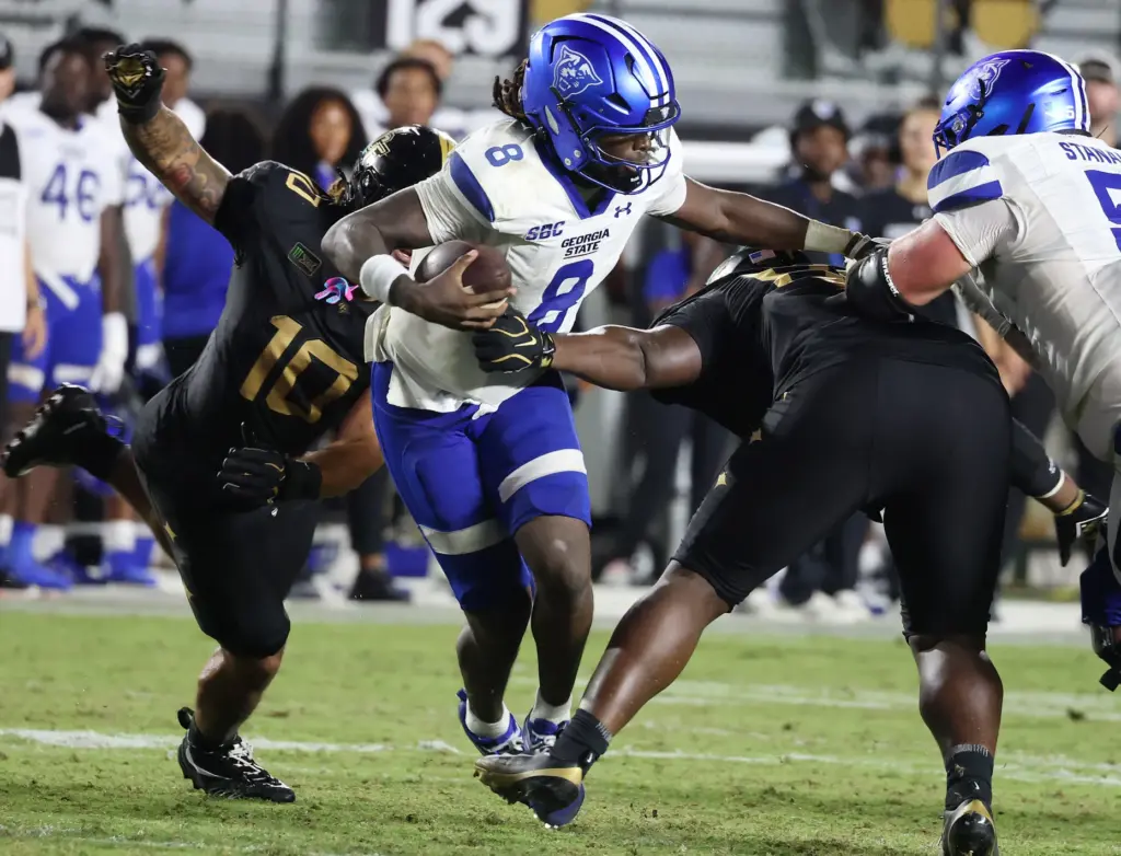 Georgia State quarterback Cameran Brown (8) runs away from UCF...