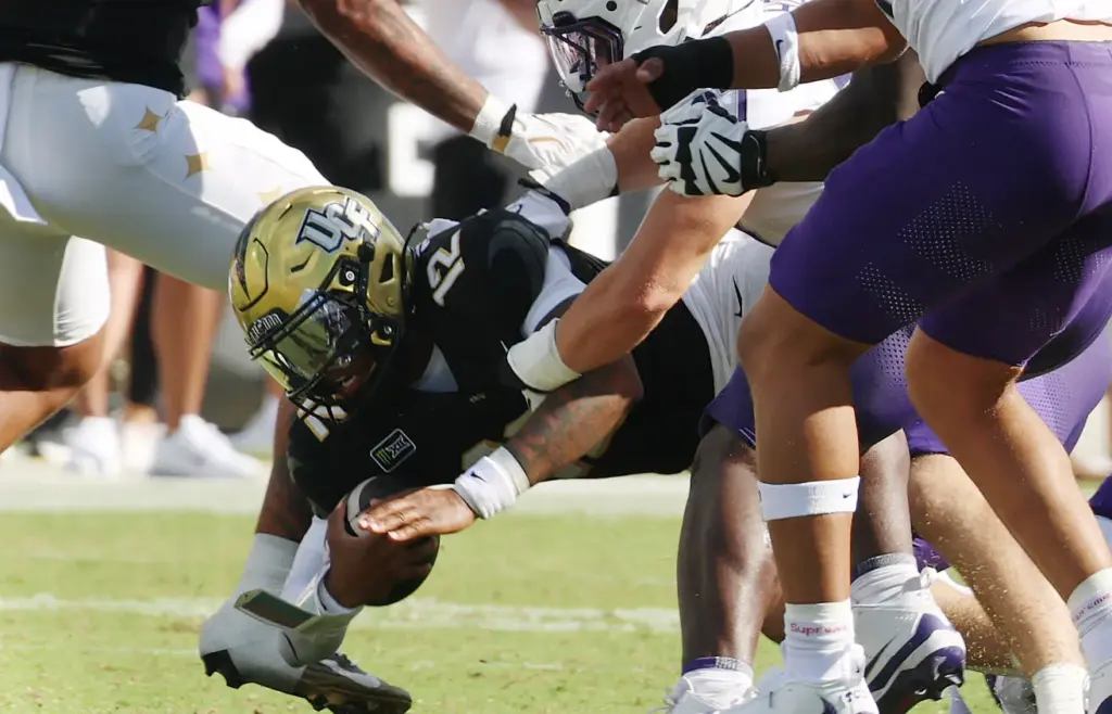 UCF quarterback Keyone Jenkins leaps through the line during the...