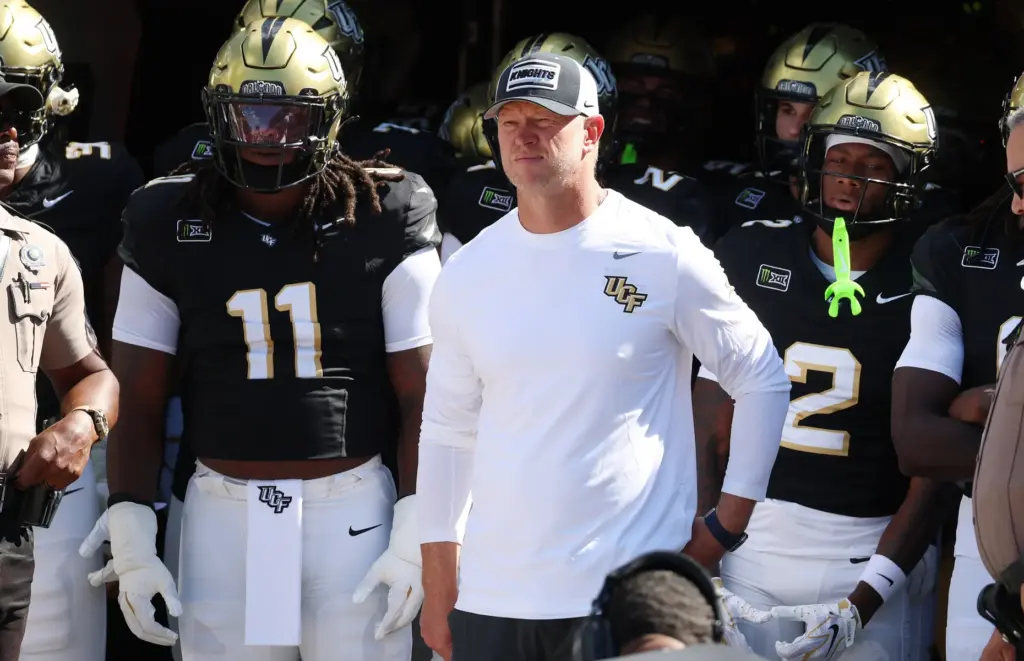 UCF coach Scott Frost stands with players before the TCU...