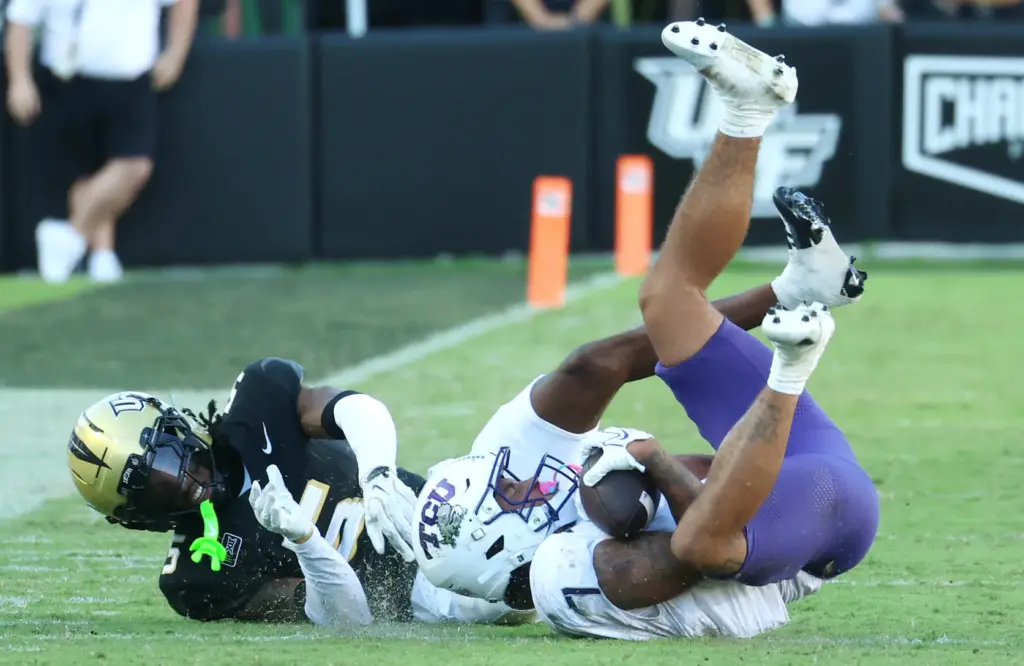 TCU receiver Jordan Dwyer (right) hangs on to a pass...